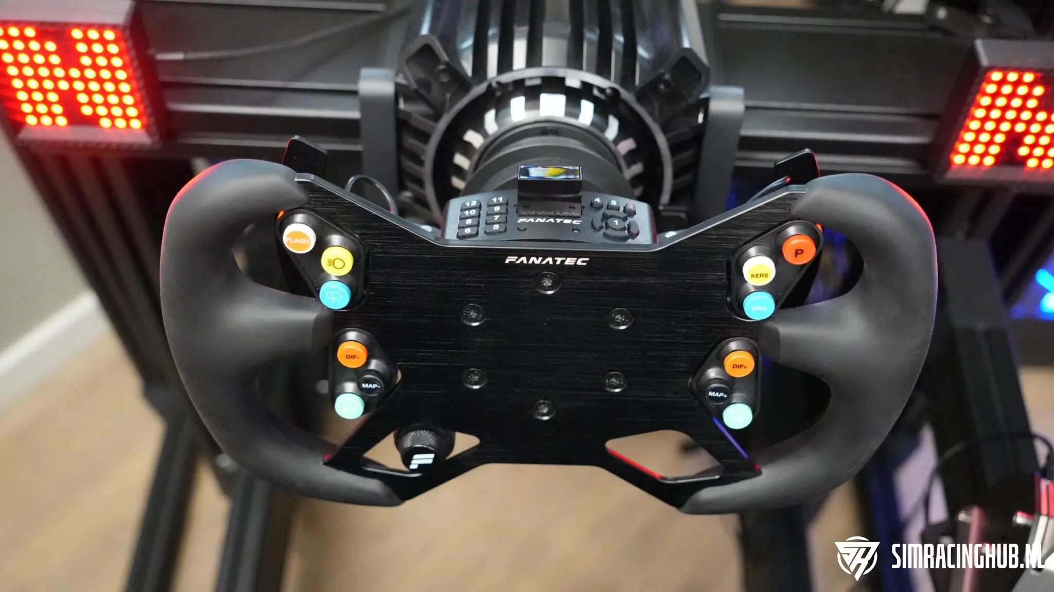 Fanatec ClubSport Wheel Rim GT3 with coloured stickers on the button clusters, mounted on the Universal Hub V2 in a sim racing rig